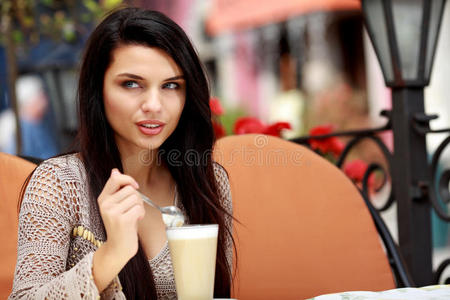 在户外咖啡馆喝茶的女人