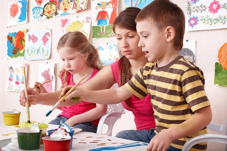 美术课上孩子们和老师一起画画。