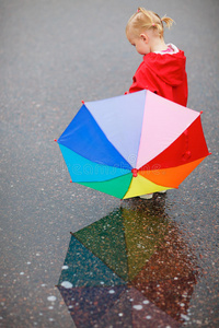 雨天带着彩色雨伞的小女孩