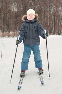 穿着运动服的男孩在森林滑雪