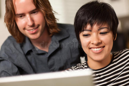 快乐的年轻男女一起使用笔记本电脑