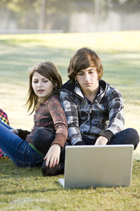 儿童在公园使用笔记本电脑