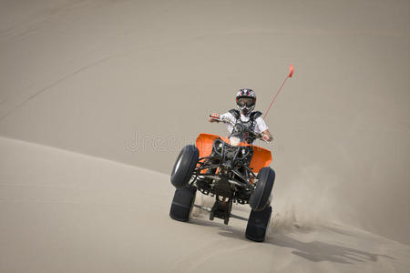 沙丘上的四轮摩托车少年