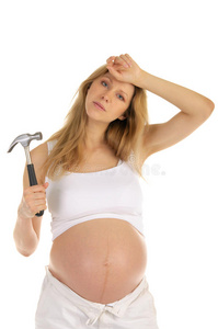 疲惫的孕妇拿着锤子
