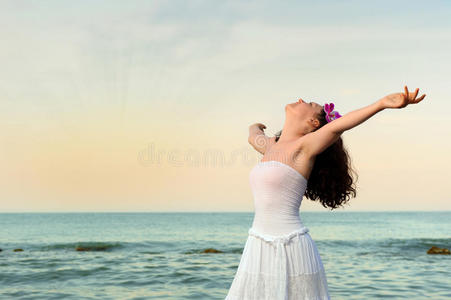 海岸上穿着白色太阳裙的女人