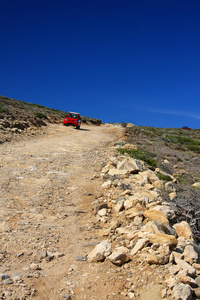 汽车行驶在山坡上的土路上。希腊