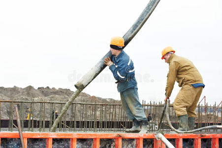 建筑工人将混凝土浇筑入模板