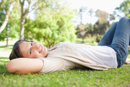 女人躺在草地上听音乐