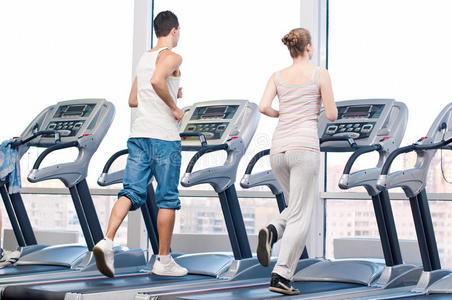 女人和男人在健身房锻炼。