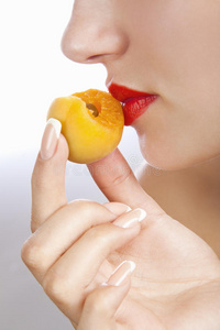女孩闻到新鲜的杏子味图片