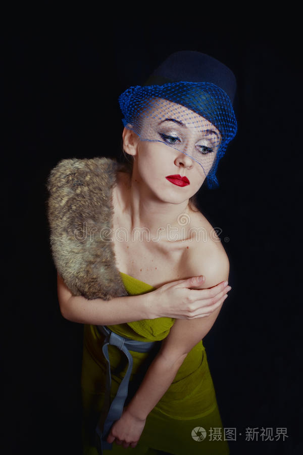 穿绿色衣服戴帽子面纱的年轻女子