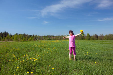 一个在草地上拿着花束的女孩