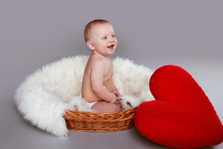 坐在篮子里的开心微笑的红心婴儿
