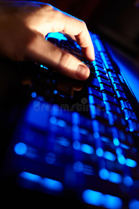 在蓝色键盘上打字的人的手。