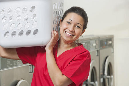 一位快乐的女员工提着洗衣篮的画像