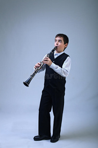 吹单簧管的男孩照片