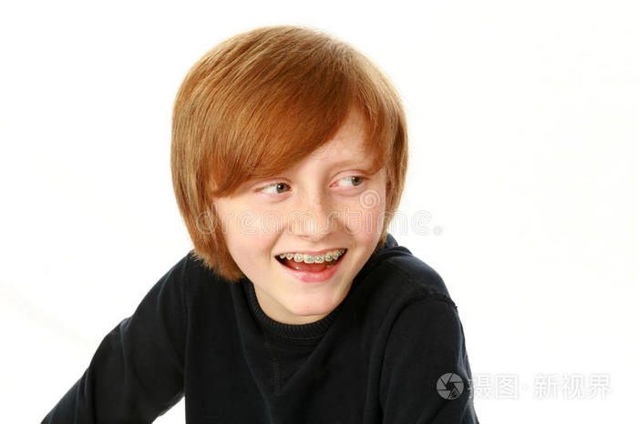 戴着牙套的微笑男孩侧目
