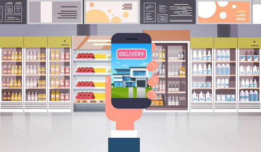 手捧智能手机在超市订购食品杂货产品送货购物理念