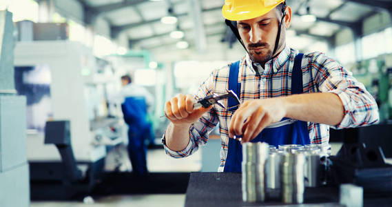 男性工人和质量控制检验在金属工业厂