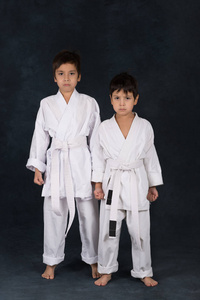 两个男孩的 karateka 在一个白色的和服立场