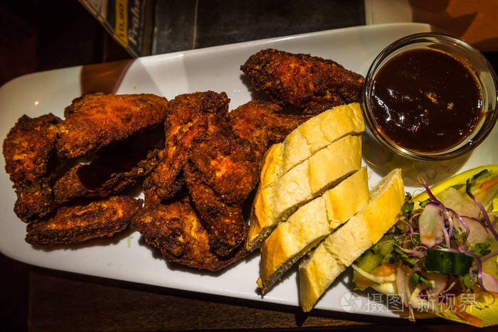 德国烤鸡肉翅烧烤酱面包和沙拉