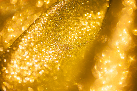 金色闪光圣诞抽象背景。闪亮的金色光芒