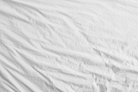 顶视图的床上用品床单或白色织物防皱纹理背景