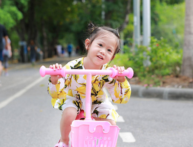 可爱的小女孩骑自行车在公园