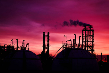 紫日落天空与工业植物, 储气罐剪影和烟雾栈在日落天空背景