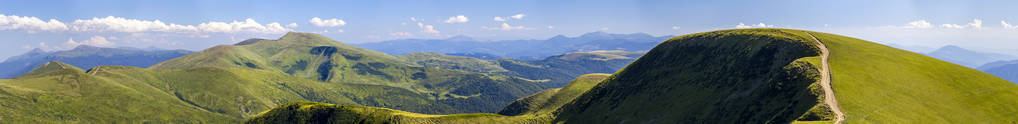 绿色丘陵山区夏季时与碎石路为全景