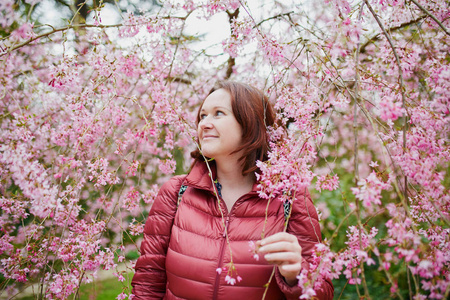 春天快乐的年轻女子享受樱花季节
