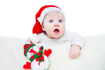 滑稽的婴孩在红色圣诞老人帽子
