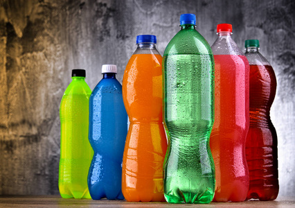 各种颜色的各式碳酸软饮料的塑料瓶照片