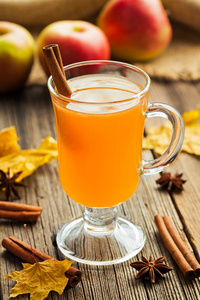 传统国产热苹果酒感恩节冬天庆祝饮料的香料。温暖的健康有机饮料。老式木制背景图片