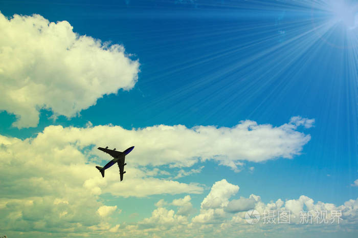 飞机飞在蓝天的映衬下的云