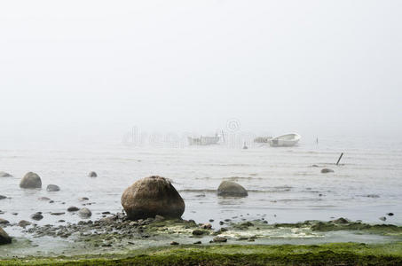 海岸边的渔船早晨有雾