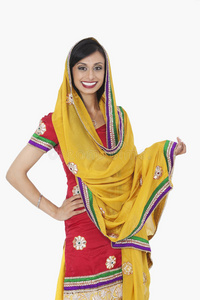 一位身着传统服装,站在白色背景下的迷人印度女性的肖像照片