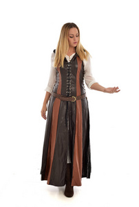 穿褐色皮革的女孩的全长画像中世纪服装, 站立姿势, 被隔绝在白色演播室背景