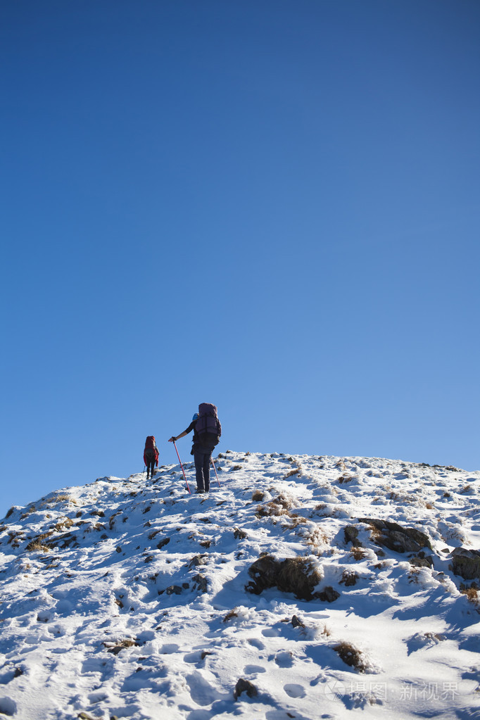 登山者爬在雪坡上照片-正版商用图片0nxghz-摄图新视界