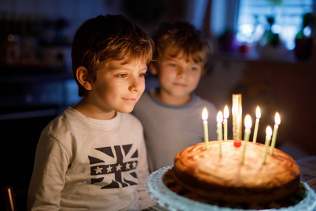 两位美丽的孩子，学龄前的小男孩，庆祝生日，吹蜡烛