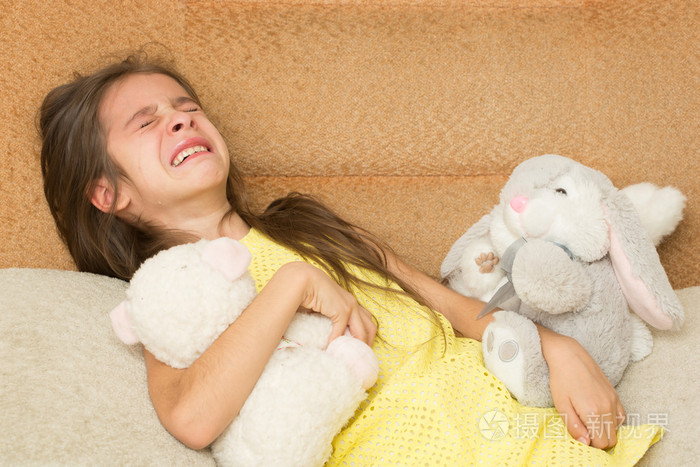 在一张椅子上哭泣的小女孩