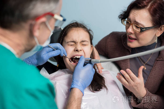 年轻的女孩，她的母亲第一次牙科访问