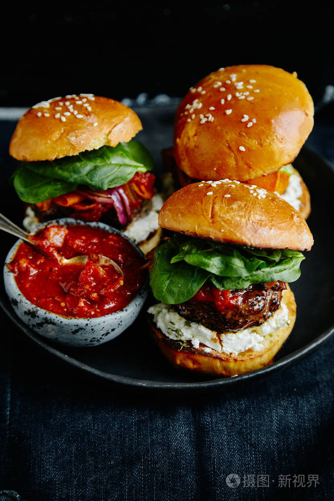 在盘子里用调味汁在木桌上吃汉堡包, 特写