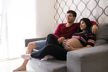 男子和孕妇看电视
