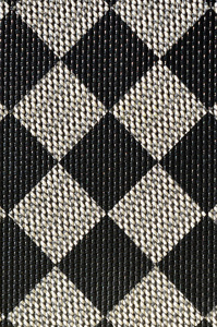 塑料质地以一种非常小的布料装订, 画在黑色和灰色的棋盘风格中。宏快照