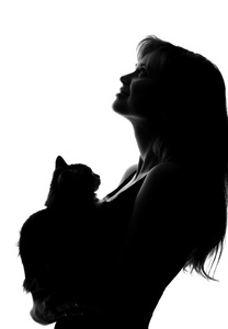 一个女人和一只猫在她的怀里的剪影