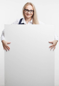 微笑的女商人显示持有大拇指白色招牌，广告横幅。隔离的室画像