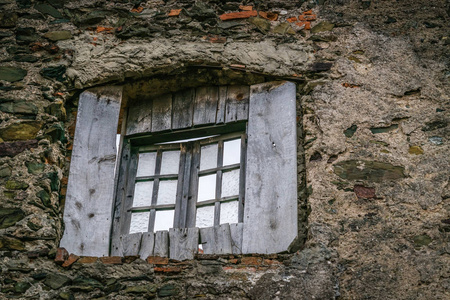 在城堡的厚墙上的老木窗