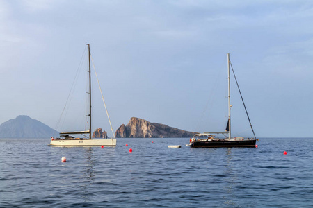 帆船附近 Panarea 附近的岩石, 风沙群岛, 西西里岛, 海日落