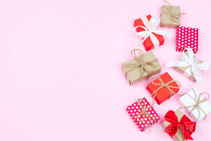 一套在粉红色背景上的各种礼品盒在平躺和顶级视图的圣诞节和情人背景